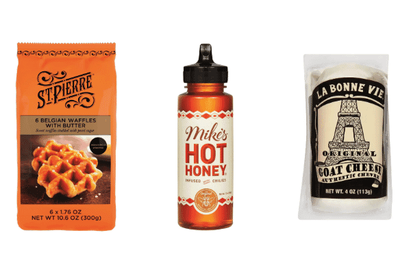A package of St. Pierre Belgian waffles, a bottle of Mikes Hot Honey, and a log of La Bonne Vie goat cheese are displayed side by side on a white background—perfect for creative cheese pairings.